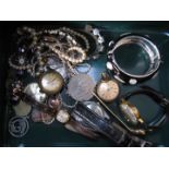 A tin and contents including wristwatches, a silver chain and pendant etc.