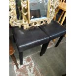 A pair of faux leather high back dining chairs
