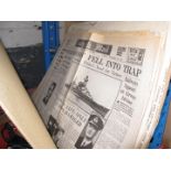A folder of vintage newspapers