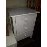 A white bedside chest of 3 drawers