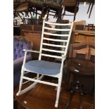 A retro white painted ladder back rocking chair