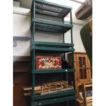 Three green plastic shelves