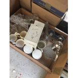 A box containing mugs, decanter, jug, glassware, etc