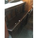 An Ercol dark elm Priory style sideboard.