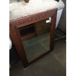 A carved oak framed mirror