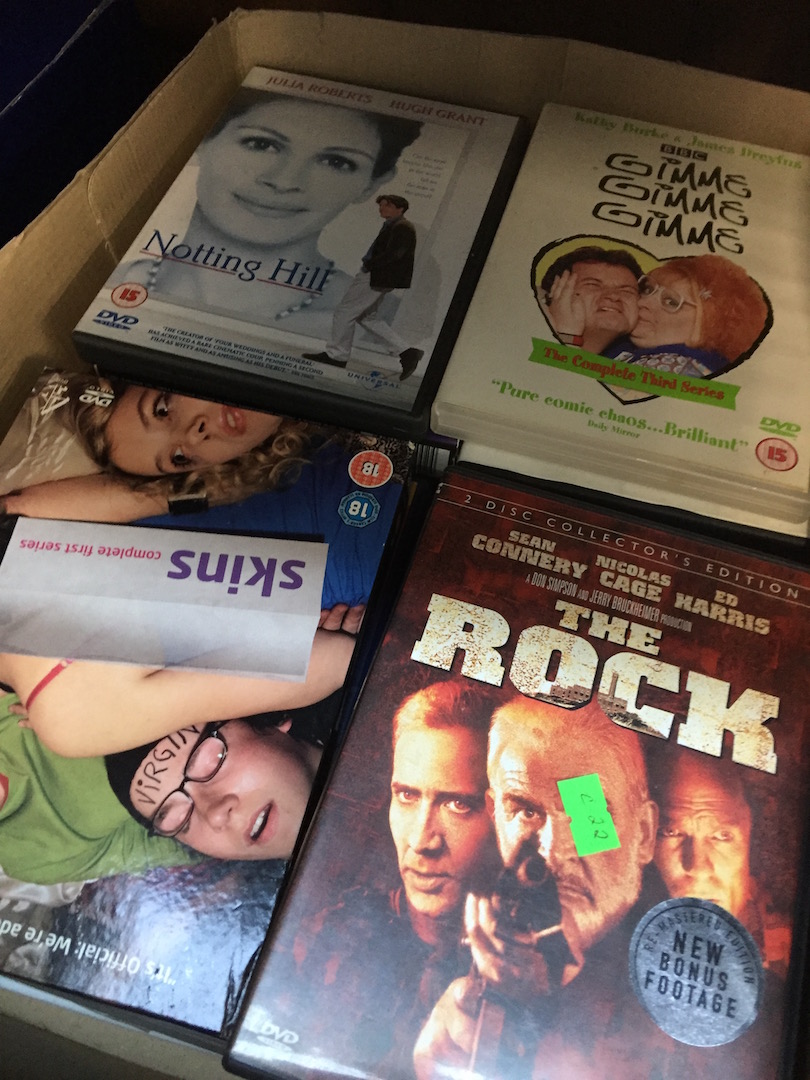 A box of DVDs mainly movies
