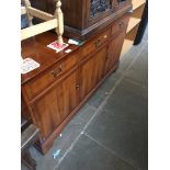 A reproduction yew wood sideboard