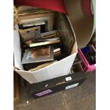 A box of picture frames and 3 lamp shades