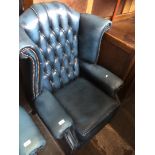 A Chesterfield blue leather wing back armchair