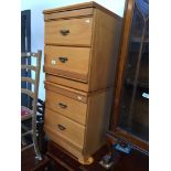 A pair of light wood effect bedside chests of drawers