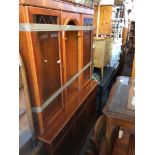 A yew wood glazed lounge cabinet