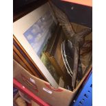 A box of misc, including a wooden eagle and some prints