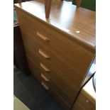 A teak effect chest of drawers