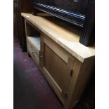 A light wood TV cabinet