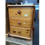 A pine chest of three drawers