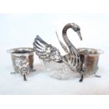 A pair of hallmarked silver salts and a silver plated and cut glass salt in the form of a swan.