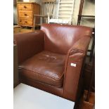 A tan leather club chair