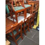A reproduction yew wood extending dining table and 8 chippendale style chairs by Arighi Bianchi