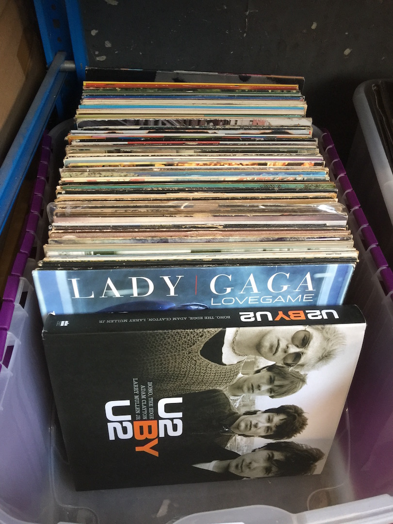 A box of LPs and 12" singles and a U2 book