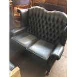 A Chesterfield blue leather wing back settee