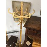 A lightwood hat and coat stand.