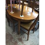 An oval teak table and four chairs