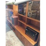 A Nathan teak bookcase with sliding glass doors and two other teak units