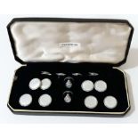 A cased Art Deco style gent's mother of pearl and white metal button and cufflink set.