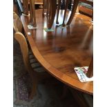 A yew wood dining table and 6 chairs