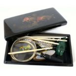 A box of items including an ivory bangle circa 1900, an agat duck, a Robertsons badge, a