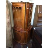 A pair of glazed yew wood corner cabinets