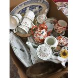 A box containing a tea set, ceramic clock, a bowl, etc