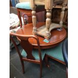 A round pedestal extending table and four chairs