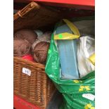 A wicker basket and a bag of knitting wool and knitting needles