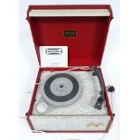 A Dansette "Popular" portable record player in red and textured grey with original instructions.