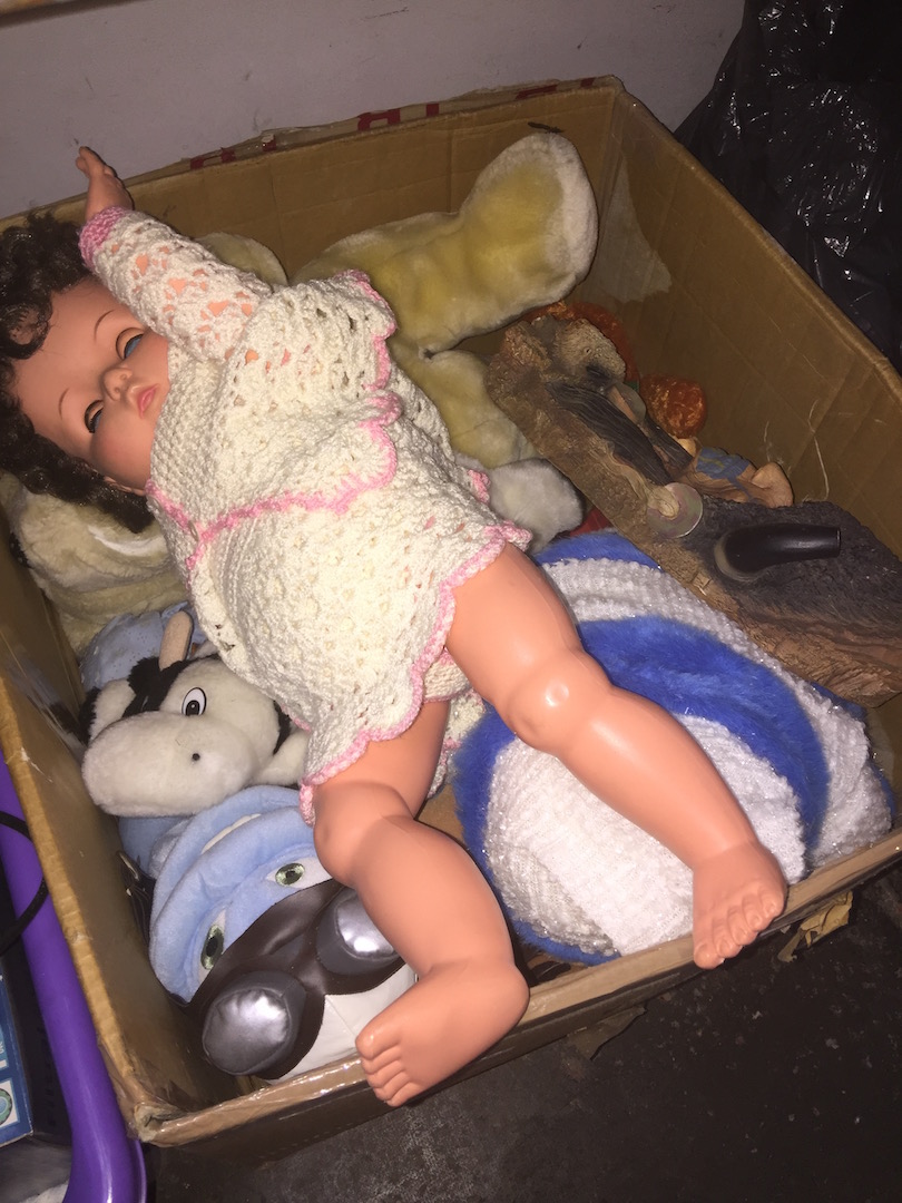A box of soft toys, a doll, etc