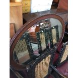 A large oval mahogany framed mirror