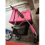 A childs pink push chair