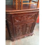 A carved hardwood Eastern style drinks cabinet