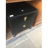 An Eastern style black two drawer cabinet