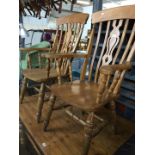 A pair of pine country kitchen armchairs