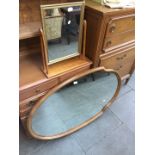 A large shield shaped mirror together with a dressing table mirror