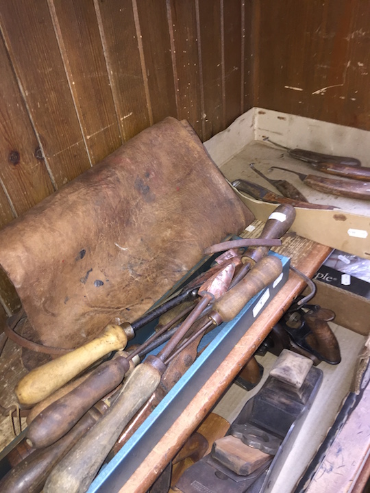 A quantity of farriers hand knives, farriers leather apron and old soldering irons