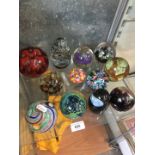 A quantity of glass paper weights including Caithness, Mdina etc