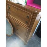 A walnut tall chest of drawers