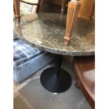 A round composite top pedestal table