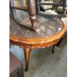 A round bergere and glass top coffee table