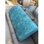 A turquoise pouffe