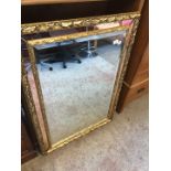 A gilt framed mirror.