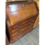 A cross banded and burr walnut 18th century bureau with later handles and plinth.